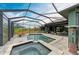 Enclosed pool with spa and an outdoor seating area with elegant patio furniture at 8304 Antwerp Cir, Port Charlotte, FL 33981