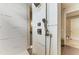Luxurious walk-in shower featuring modern fixtures, textured tilework, and a convenient hand shower at 8304 Antwerp Cir, Port Charlotte, FL 33981