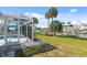 The backyard has a screened pool, patio, palm trees, and outdoor access, making it great for Gathering gatherings at 840 Park Rd, Englewood, FL 34223