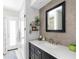 Modern bathroom features a dark vanity, decorative shelving, and stylish finishes throughout at 840 Park Rd, Englewood, FL 34223