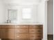 Bathroom featuring a vanity with modern hardware and a white countertop with a framed mirror at 840 Park Rd, Englewood, FL 34223
