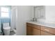 Bright bathroom featuring a modern vanity with white countertop and a shower with a stylish curtain at 840 Park Rd, Englewood, FL 34223