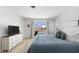 Bedroom featuring a pool view, light wood floors, and simple elegant decor at 840 Park Rd, Englewood, FL 34223