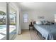 Bedroom with views of the outdoor pool and canal from the sliding glass door and windows at 840 Park Rd, Englewood, FL 34223