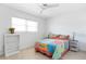 Cozy bedroom features a colorful bed, tile floors, and a ceiling fan, perfect for relaxation at 840 Park Rd, Englewood, FL 34223
