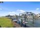 A wooden dock on the canal with a boat lift is perfect for boating and fishing enthusiasts at 840 Park Rd, Englewood, FL 34223