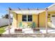 Charming front porch with seating area and a shade canopy at 840 Park Rd, Englewood, FL 34223