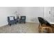 Bright sitting area with two chairs, side table and lamp over area rug at 840 Park Rd, Englewood, FL 34223