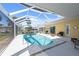 A screened pool with seating, palm trees, blue skies, and outdoor access is great for Gathering gatherings and entertaining guests at 840 Park Rd, Englewood, FL 34223