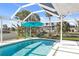 Inviting in-ground pool with screened enclosure and outdoor seating area at 840 Park Rd, Englewood, FL 34223