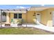 Charming porch with outdoor seating and decor, leading to a white front door at 840 Park Rd, Englewood, FL 34223