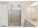 Modern bathroom with tiled shower, glass door, white vanity, and granite countertop at 9054 Calumet Blvd, Port Charlotte, FL 33981