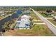 A bright single-Gathering home with a screened-in pool, lush landscaping, and waterfront access along a canal at 9325 Saint Paul Dr, Port Charlotte, FL 33981