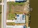 Aerial view of the property showcasing the home's layout, screened-in pool, and waterfront location at 9325 Saint Paul Dr, Port Charlotte, FL 33981