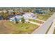 A beautiful single-Gathering home with an attached garage, a neatly manicured lawn, and waterfront access at 9325 Saint Paul Dr, Port Charlotte, FL 33981