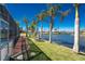 Waterfront backyard with lush landscaping and a private screened lanai, perfect for enjoying outdoor living at 9325 Saint Paul Dr, Port Charlotte, FL 33981