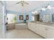 Bathroom with double vanity, soaking tub, decorative tile work, and a walk-in shower at 9325 Saint Paul Dr, Port Charlotte, FL 33981