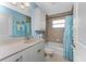 Cozy bathroom with neutral tile, a vanity with decorative pulls, and a shower-tub combination at 9325 Saint Paul Dr, Port Charlotte, FL 33981