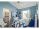 Bright bedroom with a ceiling fan, dresser, and bathroom access at 9325 Saint Paul Dr, Port Charlotte, FL 33981