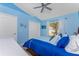 Bright bedroom featuring coastal decor, nautical accents and a view of greenery outside the window at 9325 Saint Paul Dr, Port Charlotte, FL 33981