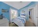 Comfortable bedroom with nautical accents, a ceiling fan, and natural light from the window at 9325 Saint Paul Dr, Port Charlotte, FL 33981