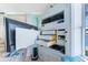 Built-in entertainment center featuring storage shelves and a disappearing television at 9325 Saint Paul Dr, Port Charlotte, FL 33981