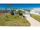 Charming home with well-maintained landscaping and a spacious driveway, showcasing curb appeal at 9325 Saint Paul Dr, Port Charlotte, FL 33981