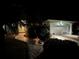 Well-lit exterior with a two-car garage, lush landscaping, and a beautifully designed walkway at 9325 Saint Paul Dr, Port Charlotte, FL 33981