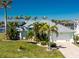 A beautiful single-Gathering home boasting lush tropical landscaping, an attached garage, and canal access at 9325 Saint Paul Dr, Port Charlotte, FL 33981