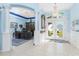 Bright foyer with high ceilings, decorative columns, chandelier, and office view, leading to a double door entry at 9325 Saint Paul Dr, Port Charlotte, FL 33981