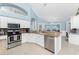 Kitchen overlooking the dining area with granite countertops and stainless steel appliances at 9325 Saint Paul Dr, Port Charlotte, FL 33981