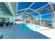 Screened lanai with fans and dining overlooking a private pool, manicured lawn, and beautiful canal at 9325 Saint Paul Dr, Port Charlotte, FL 33981