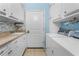 Well-organized laundry room with white cabinets, counter space, and modern appliances at 9325 Saint Paul Dr, Port Charlotte, FL 33981