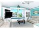 Bright living room with beautiful built-ins, water view, and coastal decor at 9325 Saint Paul Dr, Port Charlotte, FL 33981