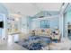 Bright living room featuring stylish furnishings, tile flooring, and a view of the outdoor pool at 9325 Saint Paul Dr, Port Charlotte, FL 33981