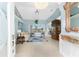 Elegant living room with tile floors, blue accents, and sliding glass doors to the pool at 9325 Saint Paul Dr, Port Charlotte, FL 33981