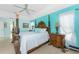 Comfortable bedroom features a decorative wood bed frame, a ceiling fan and light blue walls at 9325 Saint Paul Dr, Port Charlotte, FL 33981