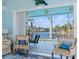 Chairs sitting at waterside patio, seen from inside the home, with pool and waterway views at 9325 Saint Paul Dr, Port Charlotte, FL 33981