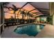 Inviting pool within a screened lanai overlooks the scenic waterway and lush landscaping, perfect for relaxation at 9325 Saint Paul Dr, Port Charlotte, FL 33981