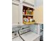 Pull-out tray in cabinet for easy access to storage items in laundry room at 9325 Saint Paul Dr, Port Charlotte, FL 33981