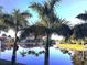 A scenic view of palm trees reflecting in calm water at this idyllic waterfront property at 9325 Saint Paul Dr, Port Charlotte, FL 33981