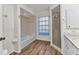 Bathroom features a shower and bathtub, wood-look floors, and a large window for natural light at 977 N Doral Ln, Venice, FL 34293