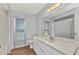 Well-lit bathroom with a spacious vanity, large mirror, and shower at 977 N Doral Ln, Venice, FL 34293