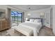 Tranquil bedroom with sliding glass doors to the outdoors and stylish, comfortable decor at 977 N Doral Ln, Venice, FL 34293