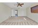 Carpeted bedroom featuring a ceiling fan, a window with blinds, and closet at 977 N Doral Ln, Venice, FL 34293
