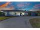 Charming home with landscaped front yard, elegant entryway, and a circular driveway at 977 N Doral Ln, Venice, FL 34293
