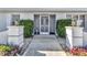 Inviting front entrance with security door, manicured hedges, and decorative lanterns at 977 N Doral Ln, Venice, FL 34293