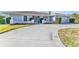 Charming home featuring a well-manicured lawn and a spacious driveway at 977 N Doral Ln, Venice, FL 34293