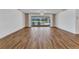 Large living room with new floors and sliding glass doors to the pool area at 977 N Doral Ln, Venice, FL 34293