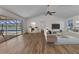 Inviting living room with hardwood floors, neutral decor, and sliding glass doors to the pool area at 977 N Doral Ln, Venice, FL 34293